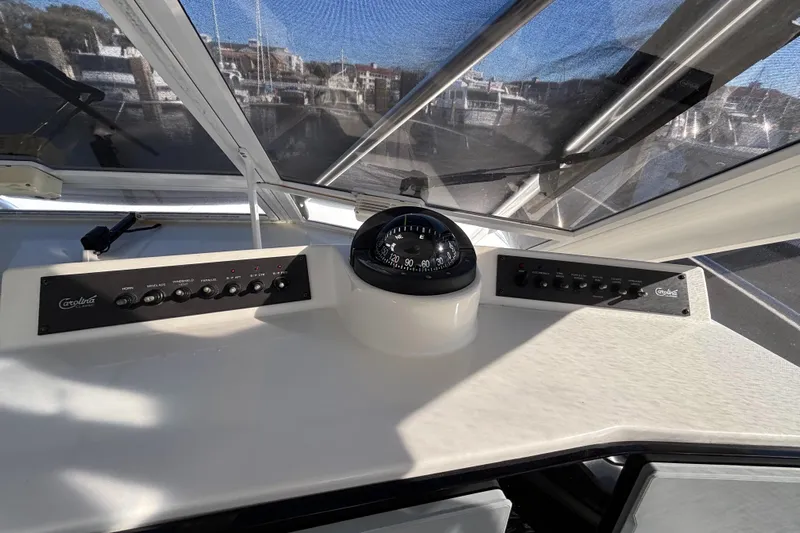 Reel Deal Yacht Photos Pics 2001 Carolina Classic 35 boat dashboard with compass and control panels.