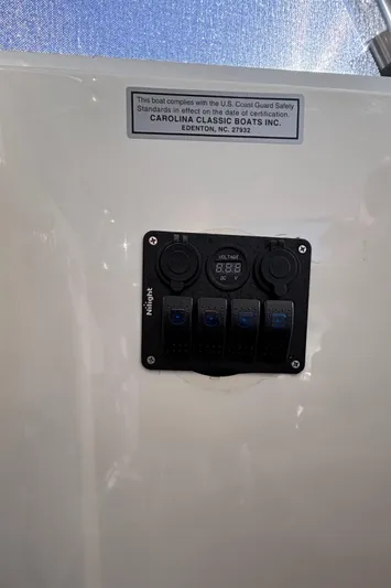Reel Deal Yacht Photos Pics Control panel on a 2001 Carolina Classic 35 boat with safety compliance label.