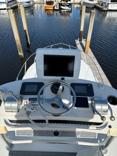 Reel Deal Yacht Photos Pics Helm of 2001 Carolina Classic 35 boat with navigation equipment at marina.