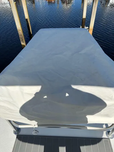 Reel Deal Yacht Photos Pics Covered area on a 2001 Carolina Classic 35 boat, docked by the water.