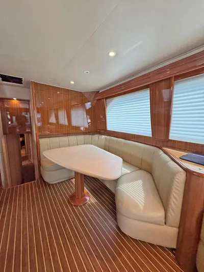  Yacht Photos Pics Luxurious interior of 2008 Viking 68 Convertible yacht with elegant wood finishes and plush seating.