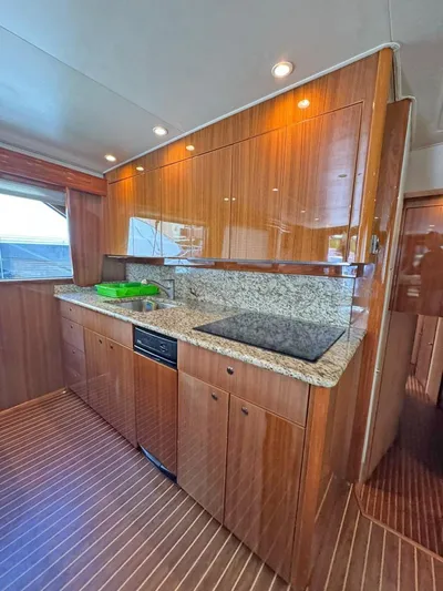  Yacht Photos Pics Luxurious kitchen interior of 2008 Viking 68 Convertible yacht with wood cabinetry and granite countertops.