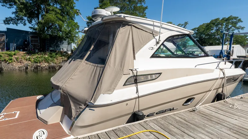  Yacht Photos Pics 2012 Regal 35 Sport Coupe docked, featuring sleek design and covered cockpit.
