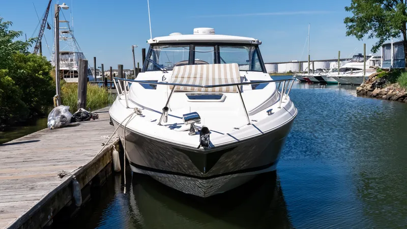  Yacht Photos Pics 2012 Regal 35 Sport Coupe docked in a serene marina setting.