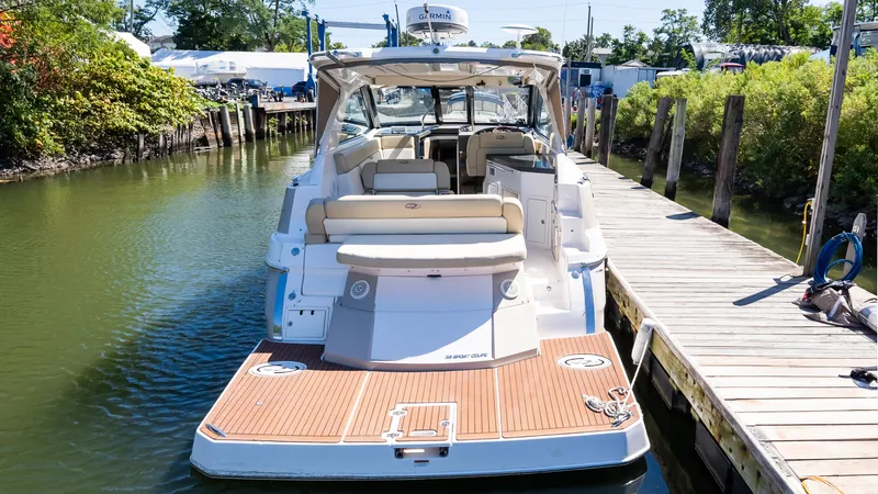  Yacht Photos Pics 2012 Regal 35 Sport Coupe docked, showcasing spacious deck and seating area.