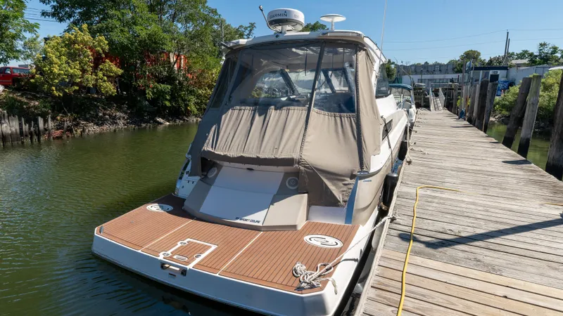  Yacht Photos Pics 2012 Regal 35 Sport Coupe docked on a sunny day, showcasing sleek design and spacious deck.