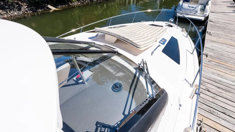  Yacht Photos Pics 2012 Regal 35 Sport Coupe docked by a wooden pier, sunny day.