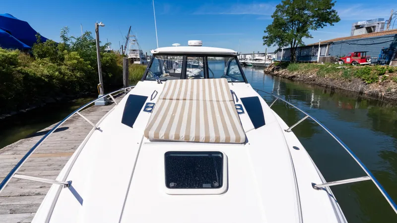  Yacht Photos Pics 2012 Regal 35 Sport Coupe yacht docked in a serene marina setting.