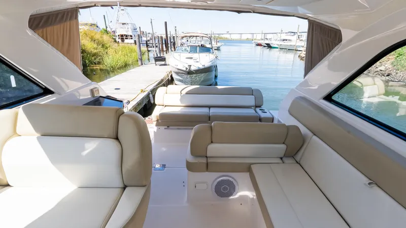  Yacht Photos Pics 2012 Regal 35 Sport Coupe interior with beige seating, docked at a marina.