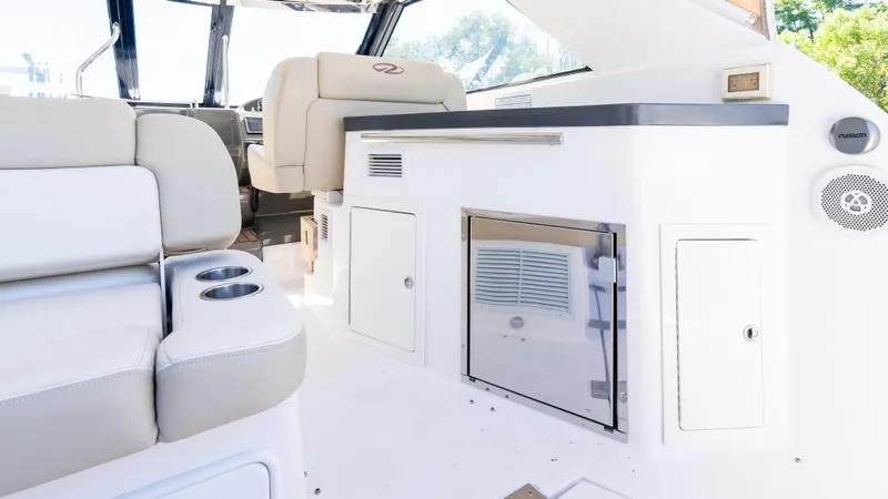  Yacht Photos Pics 2012 Regal 35 Sport Coupe interior with seating and kitchenette area.