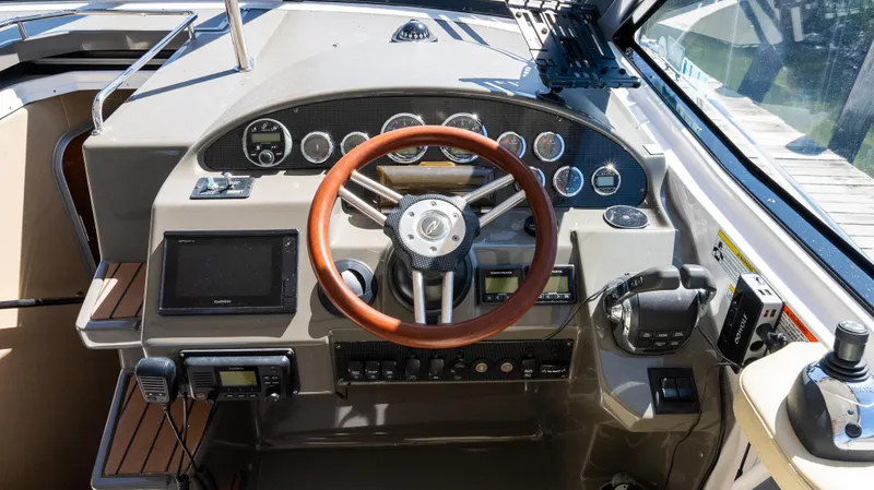  Yacht Photos Pics Cockpit of 2012 Regal 35 Sport Coupe with wooden steering wheel and modern controls.