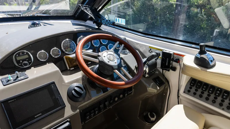  Yacht Photos Pics Cockpit of 2012 Regal 35 Sport Coupe with wooden steering wheel and modern controls.