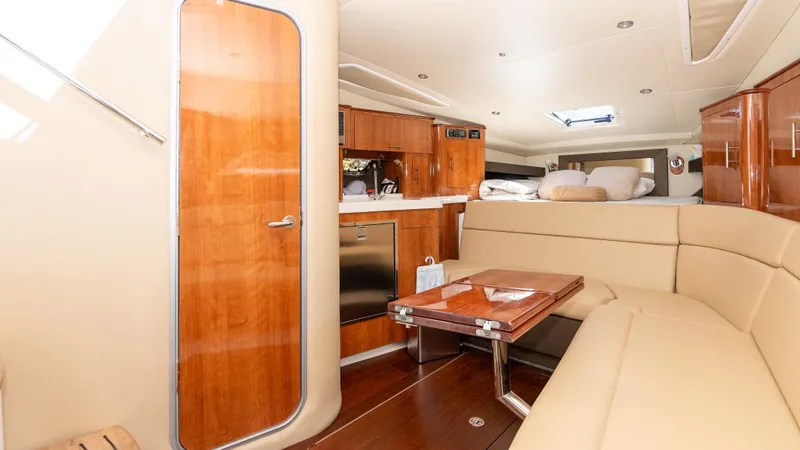  Yacht Photos Pics Interior of 2012 Regal 35 Sport Coupe with wood finishes and beige seating.