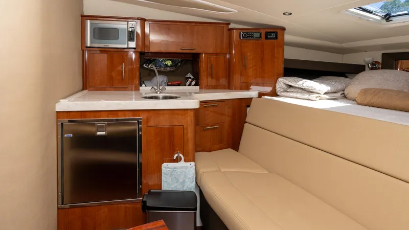  Yacht Photos Pics Interior of 2012 Regal 35 Sport Coupe with kitchenette and seating area.