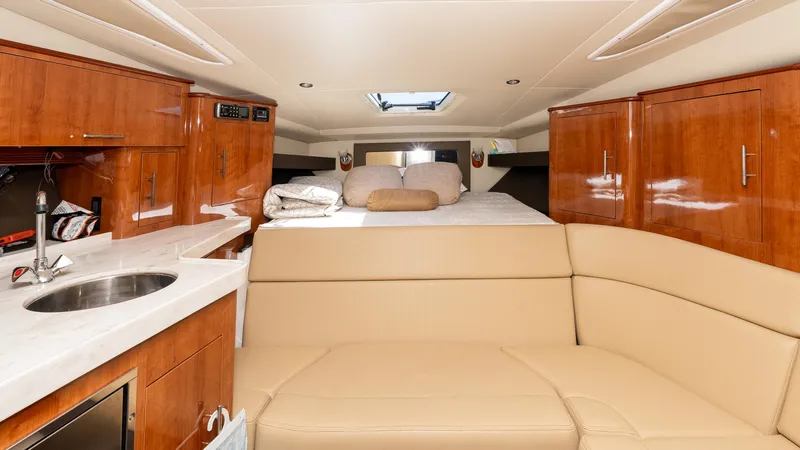  Yacht Photos Pics Interior of 2012 Regal 35 Sport Coupe with kitchenette and cozy seating area.