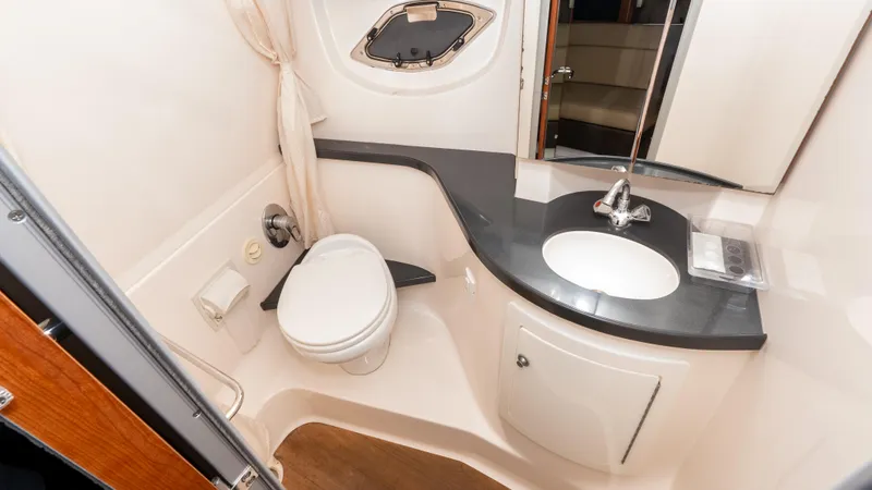  Yacht Photos Pics 2012 Regal 35 Sport Coupe bathroom with toilet, sink, and mirror.