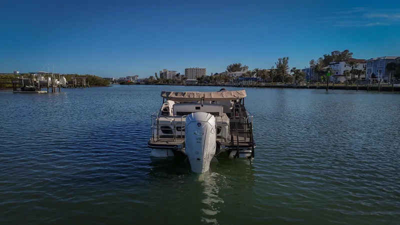  Yacht Photos Pics 2021 Bennington 27 QX boat on calm water with scenic shoreline backdrop.
