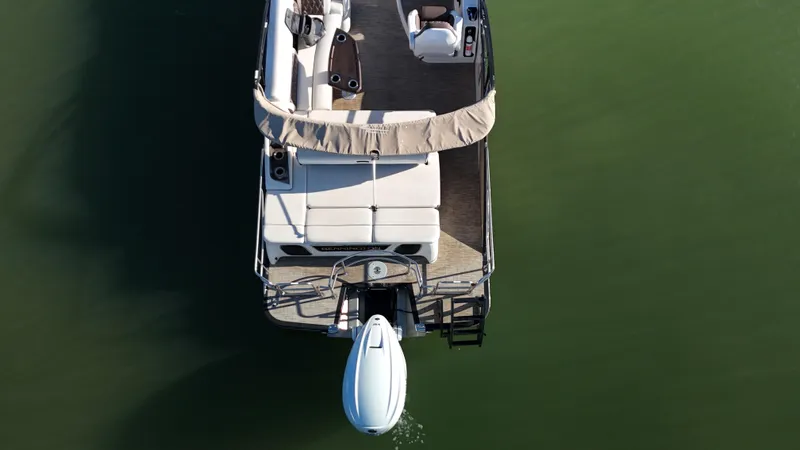 Yacht Photos Pics 2021 Bennington 27 QX pontoon boat on calm green water, aerial view.