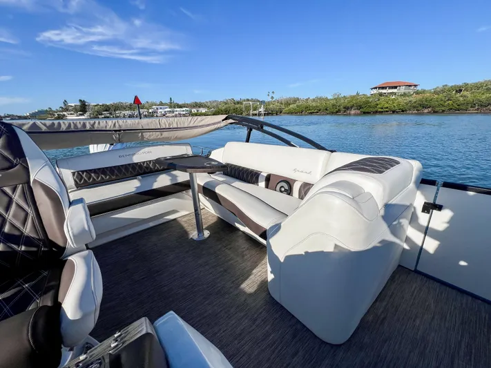  Yacht Photos Pics 2021 Bennington 27 QX boat interior with luxurious seating on a sunny day.