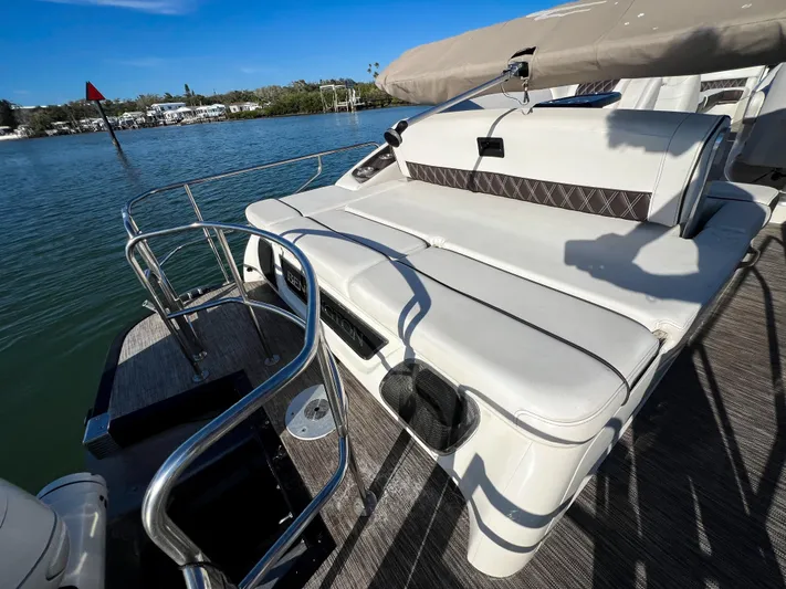  Yacht Photos Pics 2021 Bennington 27 QX boat with luxurious seating, docked by a serene waterfront.