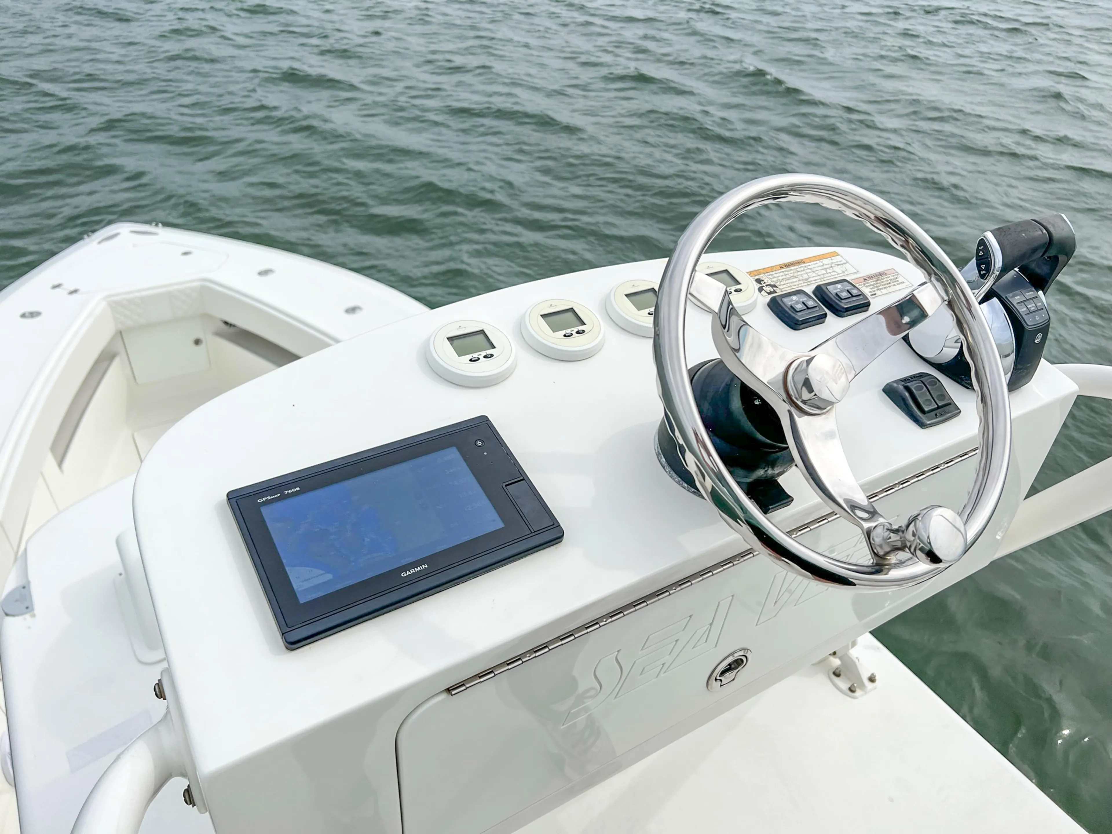  Yacht Photos Pics 2017 SeaVee 390z Center Console boat helm with steering wheel and navigation display.