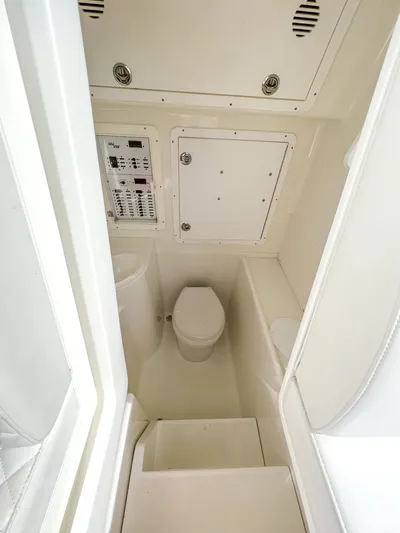  Yacht Photos Pics 2017 SeaVee 390z Center Console boat interior with toilet and control panel.