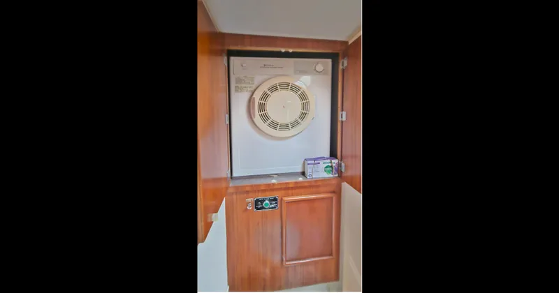 Tizzylizzy Yacht Photos Pics 1989 Post 43 Convertible interior with wooden cabinetry and built-in appliance.