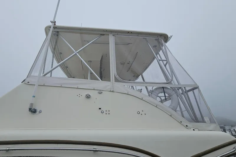 Tizzylizzy Yacht Photos Pics 1989 Post 43 Convertible boat with enclosed flybridge on a foggy day.