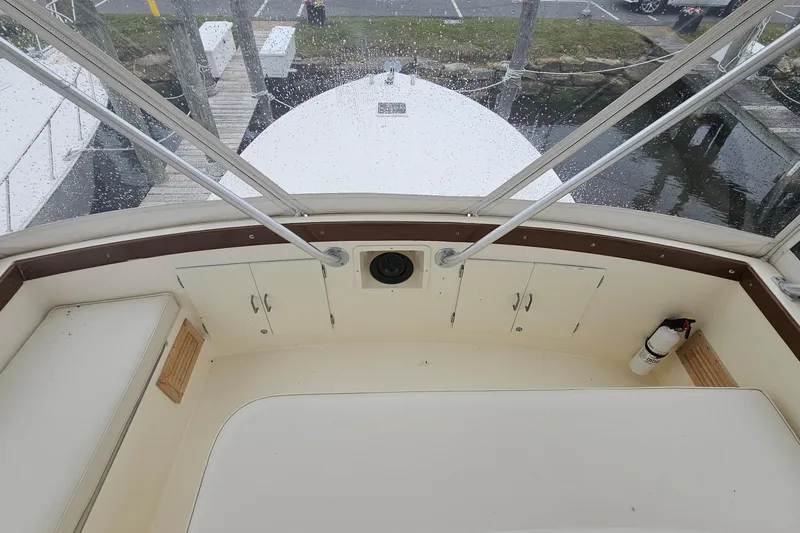 Tizzylizzy Yacht Photos Pics 1989 Post 43 Convertible boat interior with seating and storage, docked near water.