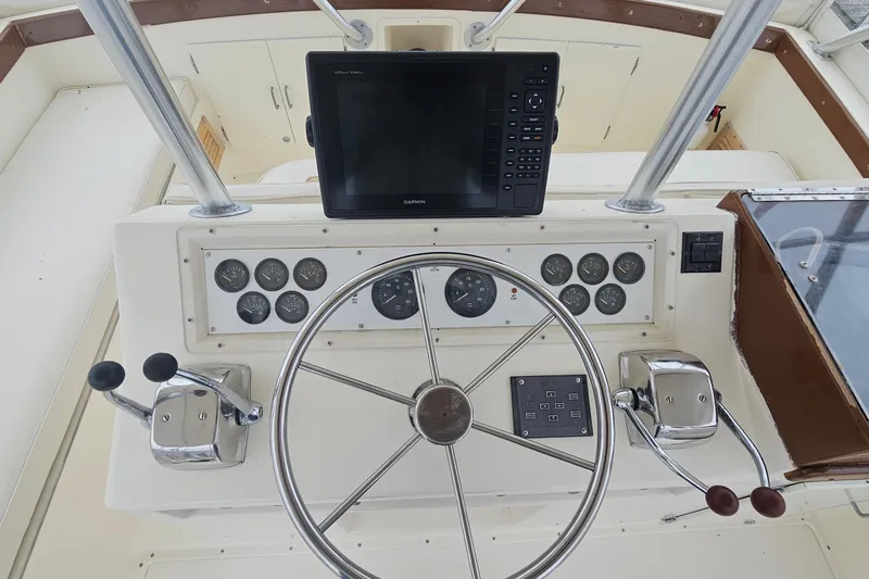Tizzylizzy Yacht Photos Pics 1989 Post 43 Convertible boat dashboard with steering wheel and navigation controls.