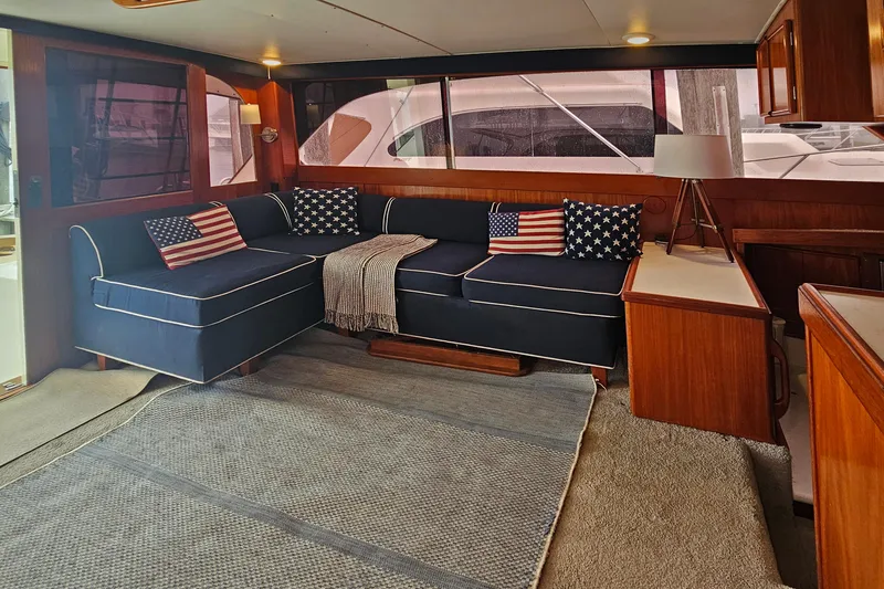 Tizzylizzy Yacht Photos Pics Luxurious 1989 Post 43 Convertible yacht interior with navy seating and American flag pillows.