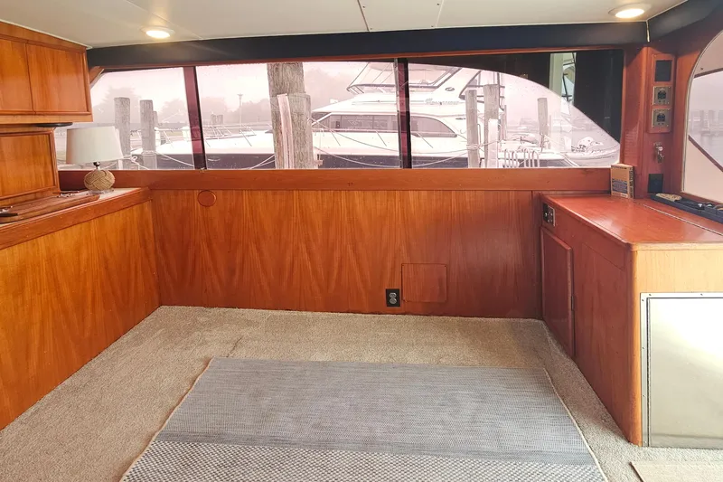 Tizzylizzy Yacht Photos Pics Interior of 1989 Post 43 Convertible yacht with wood paneling and carpeted floor.