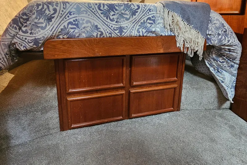 Tizzylizzy Yacht Photos Pics Wooden storage cabinet under bed with patterned blanket in 1989 Post 43 Convertible.