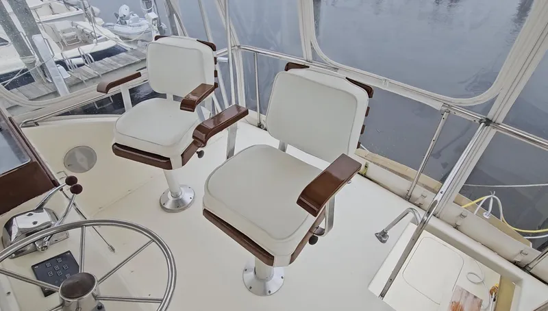 Tizzylizzy Yacht Photos Pics Two white captain's chairs on a 1989 Post 43 Convertible yacht deck.