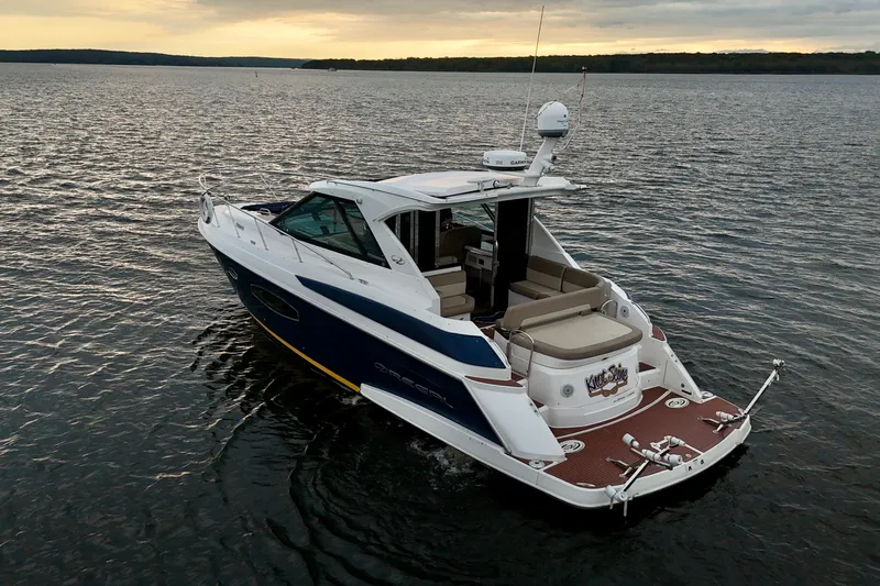 Knot Seine Yacht Photos Pics 2013 Regal 42 Sport Coupe yacht cruising on a calm lake at sunset.