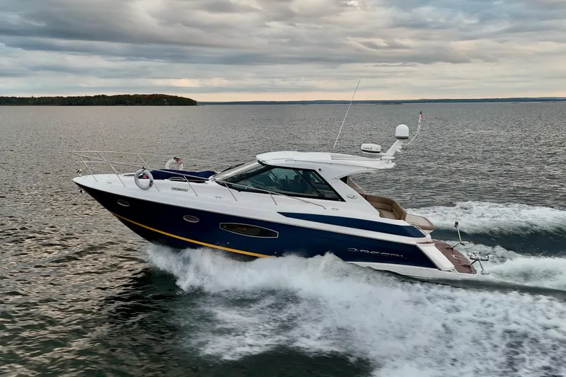 Knot Seine Yacht Photos Pics 2013 Regal 42 Sport Coupe cruising on open water under cloudy skies.