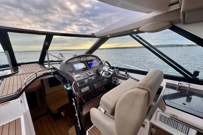 Knot Seine Yacht Photos Pics Helm of 2013 Regal 42 Sport Coupe yacht with scenic water view at sunset.
