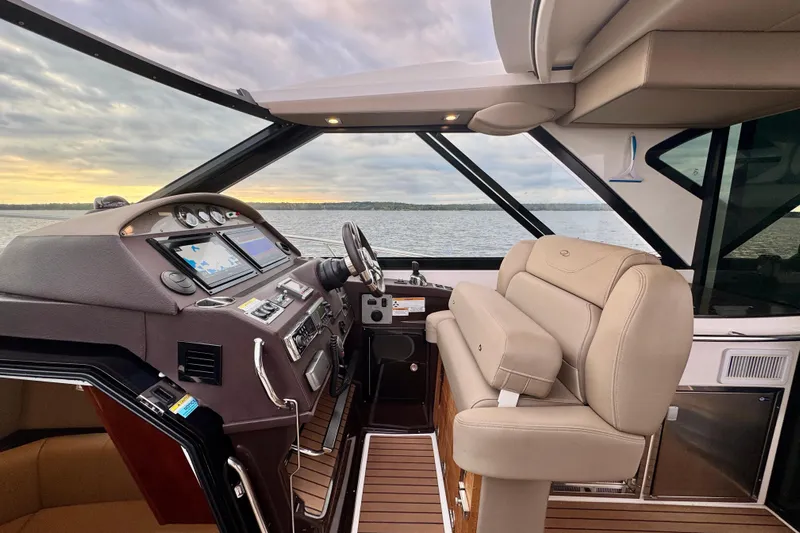 Knot Seine Yacht Photos Pics Interior of 2013 Regal 42 Sport Coupe yacht with modern helm and leather seating.