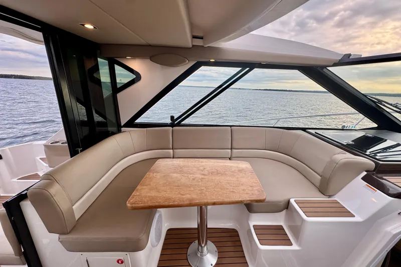 Knot Seine Yacht Photos Pics Luxurious interior of 2013 Regal 42 Sport Coupe yacht with elegant seating and wooden table.