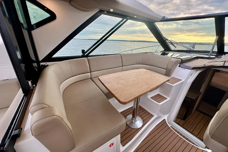 Knot Seine Yacht Photos Pics Luxurious interior of 2013 Regal 42 Sport Coupe yacht with elegant seating and wooden table.