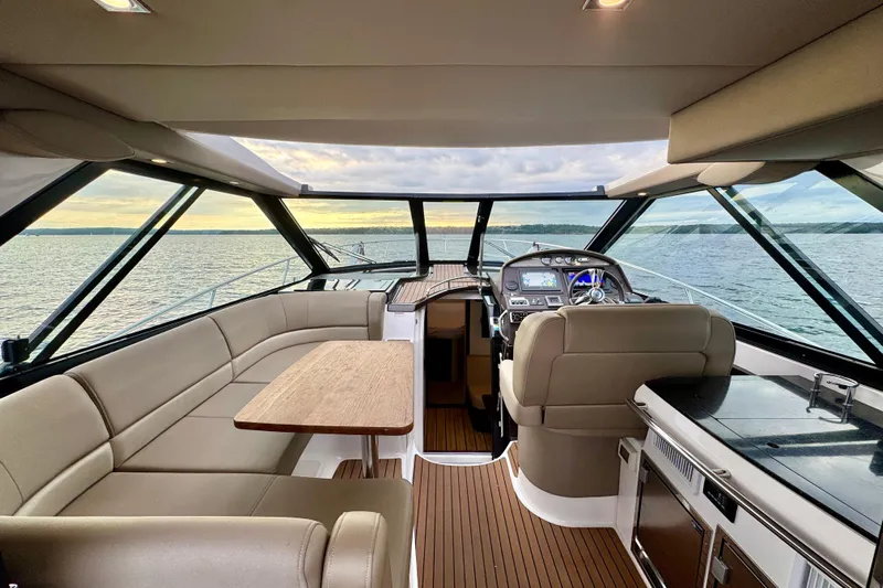 Knot Seine Yacht Photos Pics Interior of 2013 Regal 42 Sport Coupe yacht with luxurious seating and helm.