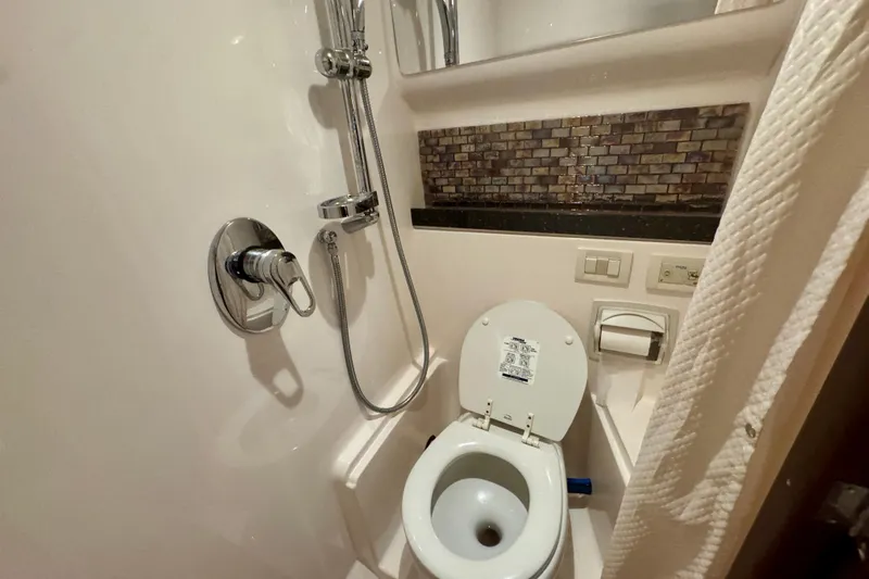 Knot Seine Yacht Photos Pics Bathroom interior of 2013 Regal 42 Sport Coupe with shower and toilet.