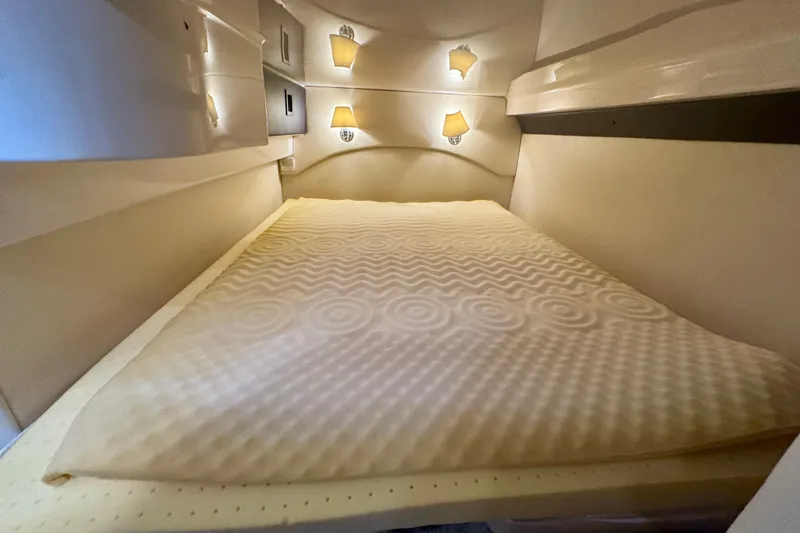 Knot Seine Yacht Photos Pics Cozy cabin interior of 2013 Regal 42 Sport Coupe with soft lighting and comfortable bedding.