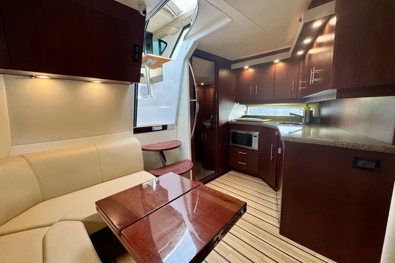 Knot Seine Yacht Photos Pics Luxurious interior of 2013 Regal 42 Sport Coupe yacht with modern kitchen and seating area.