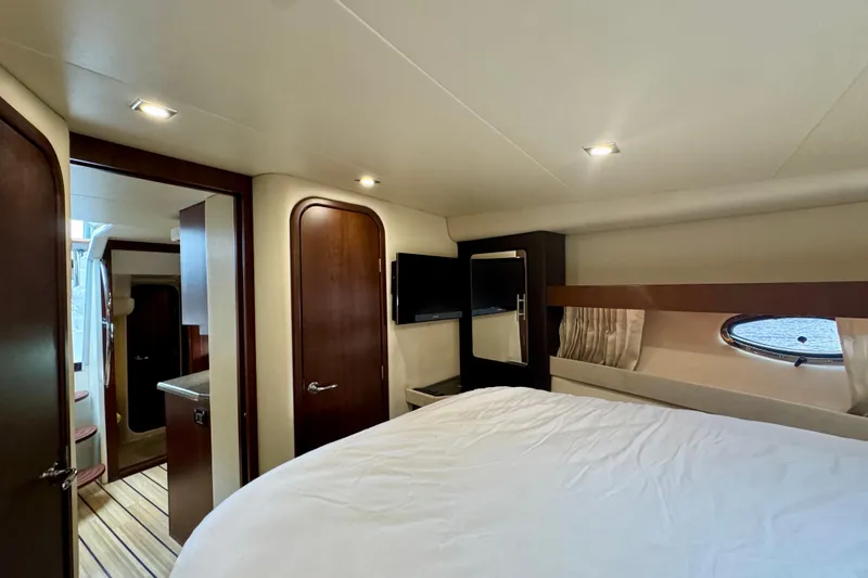 Knot Seine Yacht Photos Pics Luxurious interior of 2013 Regal 42 Sport Coupe yacht bedroom with modern amenities.