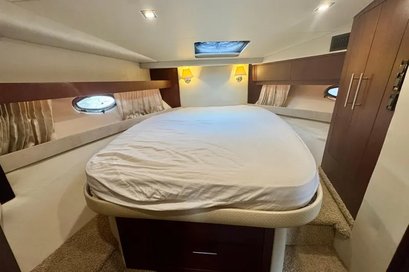 Knot Seine Yacht Photos Pics Luxurious bedroom interior of 2013 Regal 42 Sport Coupe yacht with cozy lighting.