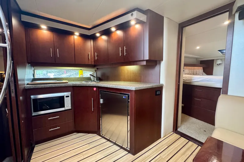 Knot Seine Yacht Photos Pics Luxurious kitchen interior of 2013 Regal 42 Sport Coupe yacht with modern amenities.
