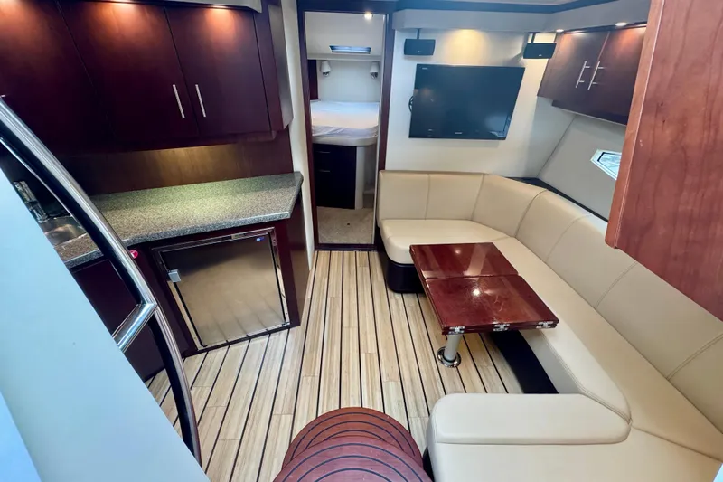 Knot Seine Yacht Photos Pics Luxurious interior of 2013 Regal 42 Sport Coupe with modern seating and kitchenette.