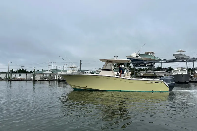  Yacht Photos Pics 2020 Grady-White Canyon 271 boat cruising in a marina, overcast sky.