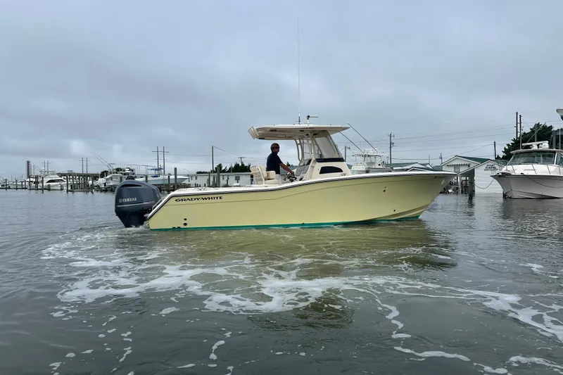  Yacht Photos Pics 2020 Grady-White Canyon 271 boat on water, featuring Yamaha engine, overcast sky.